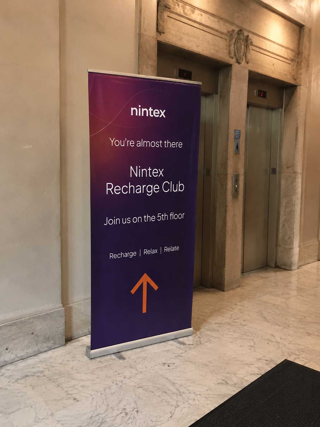 Nintex Recharge Club roll-up banner in lobby